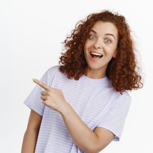 hey-check-this-out-happy-redhead-girl-inviting-you-pointing-finger-right-and-smiling-amazed-standing-on-white_176420-40910